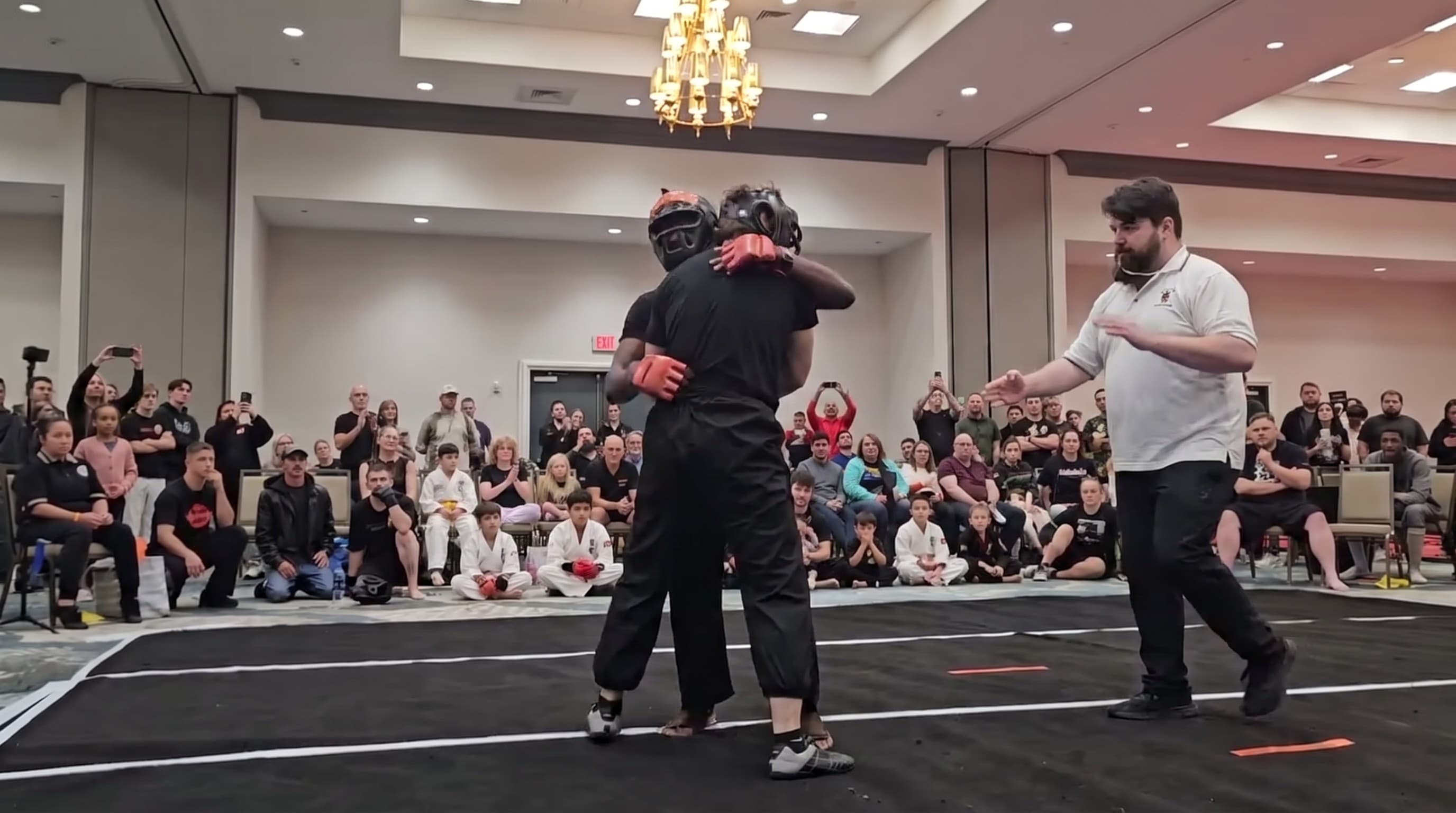 Two students sparring with headgear